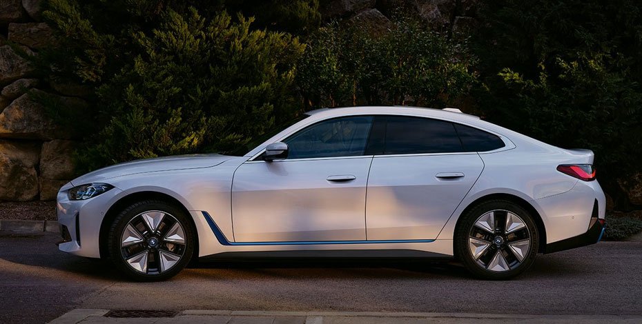 BMW i4 2025 electric luxury sedan side view in metallic blue
