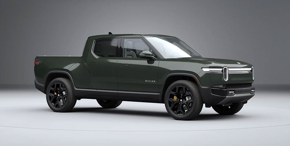 Rivian R1T electric pickup truck in forest green on an off-road trail